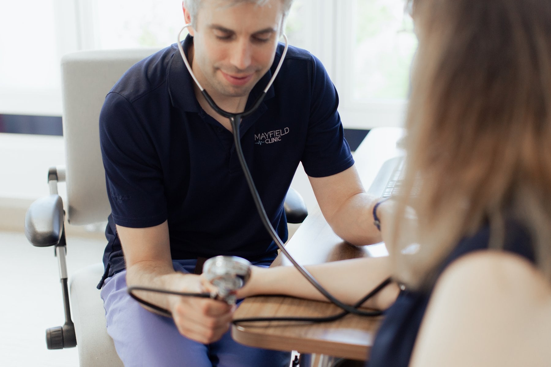 A Mayfield Clinic GP taking a patient's blood pressure